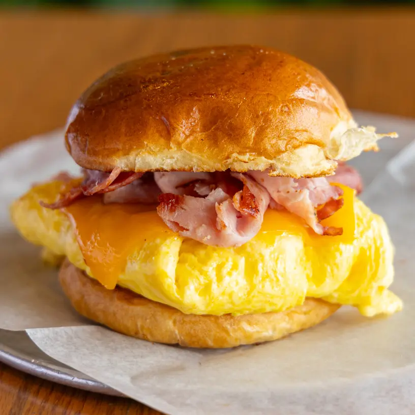 Our scratch-made menu features our popular Breakfast Bomb, a go-to sandwich with eggs, cheese, and ham on a toasted, pillowy brioche bun